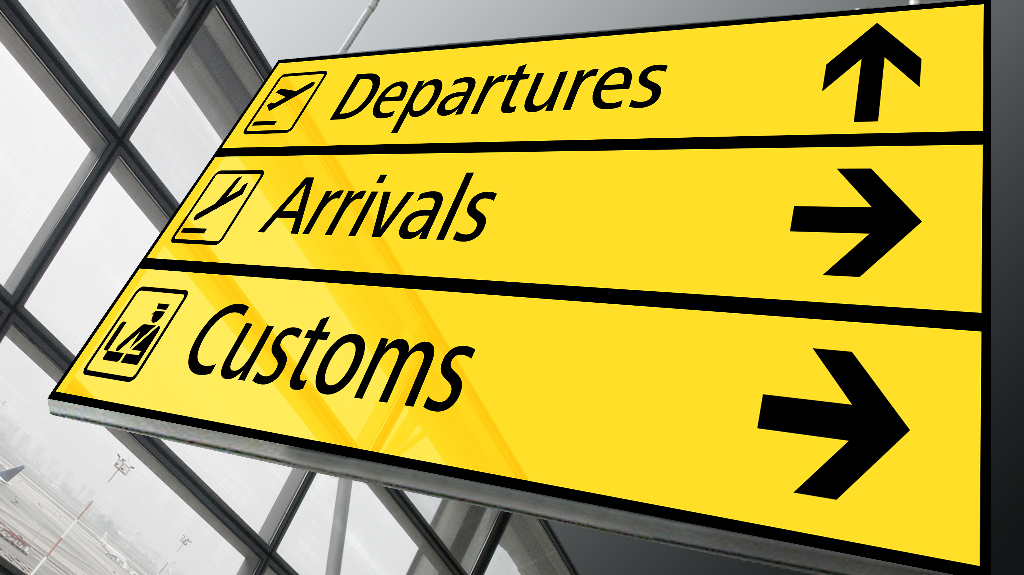 UK import broker customs sign at an airport arrivals and departures terminal